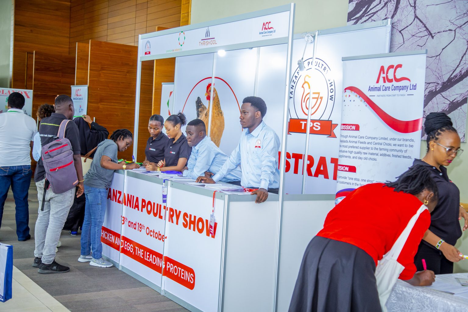 Visitors signing in at the Tanzania Poultry Show registration desk.