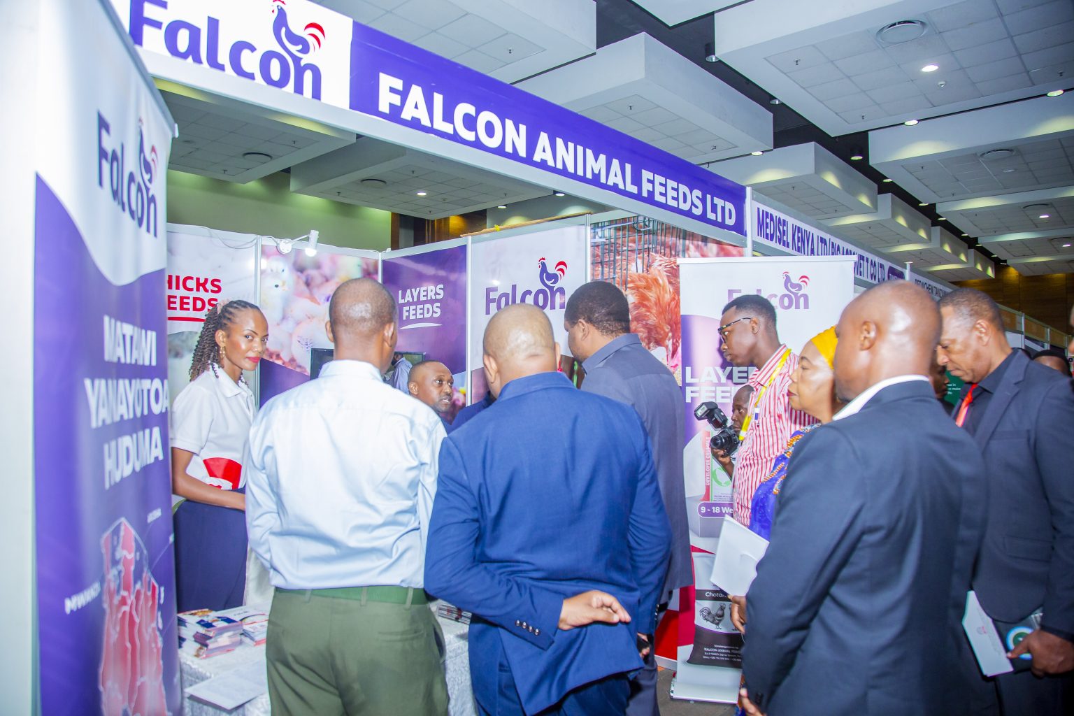 Visitors gathered around an animal feeds exhibition stand.